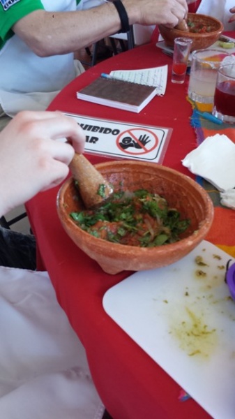 The beginnings of Salsa Verde using tomatillo. Instructions is to 'mush and roll' the pestle in the bowl to turn the ingredients into the desired consistency. processo