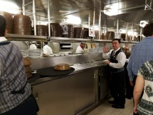 Food pickup area. Items are cooked to order and plated here. Service staff check each order, put a cover on the plate, and take it to the dining room.